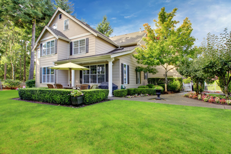 A serene image of a house with a lush lawn.