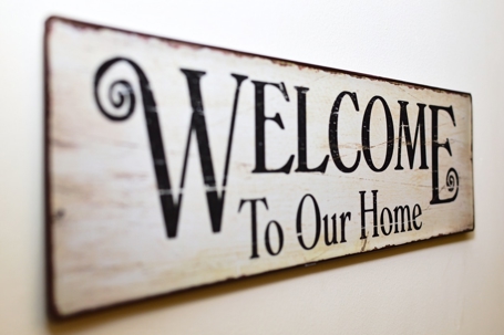 A sign says, "Welcome to Our Home"