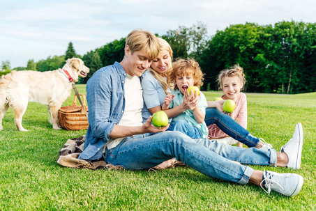 A family of four enjoys a sunny picnic