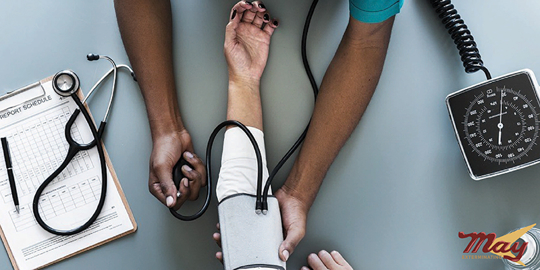 Overhead shot of a doctor taking a patient's blood pressure.