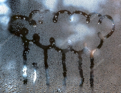 Steamy window with a drawing of a rainy cloud.