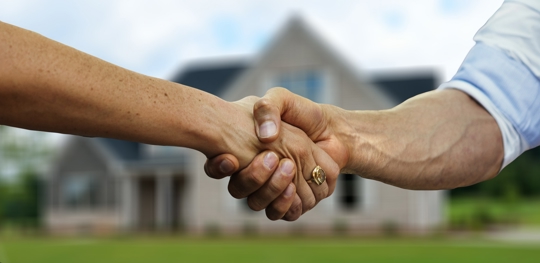 Handshake of a realtor and a home buyer