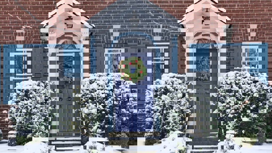 A home is laden with fresh snow.