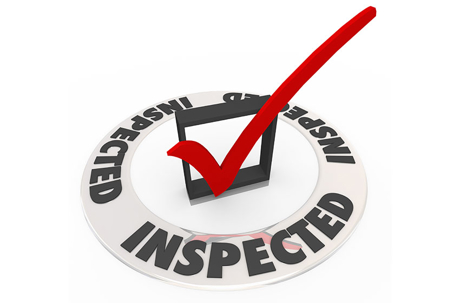 An "Inspected" graphic. A white badge with "INSPECTED" text in a circle, features a black box with a prominent red checkmark.